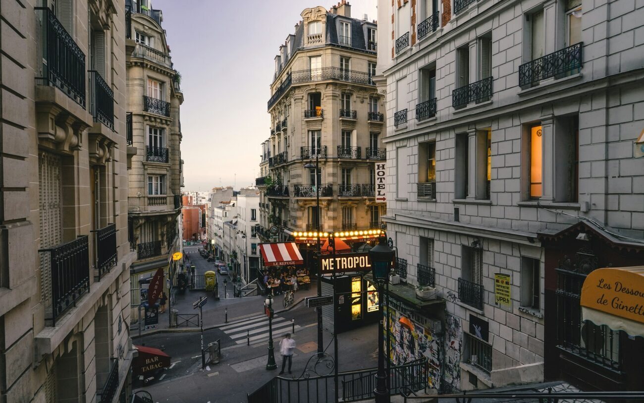 A Paris street at dusk, seen from the top of a flight of steps