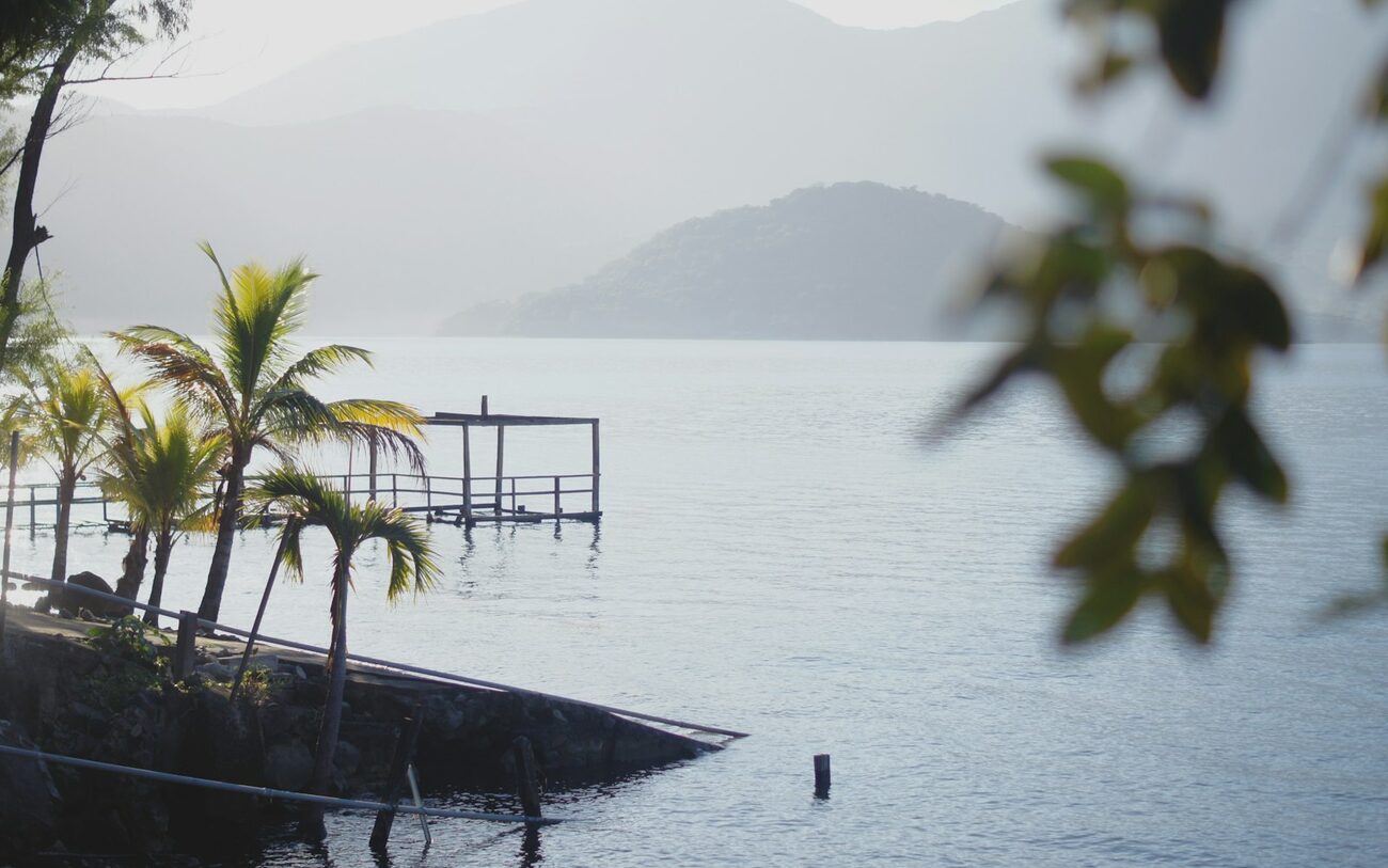 Palm-lined shore of Lake Coatepeque, El Salvador.