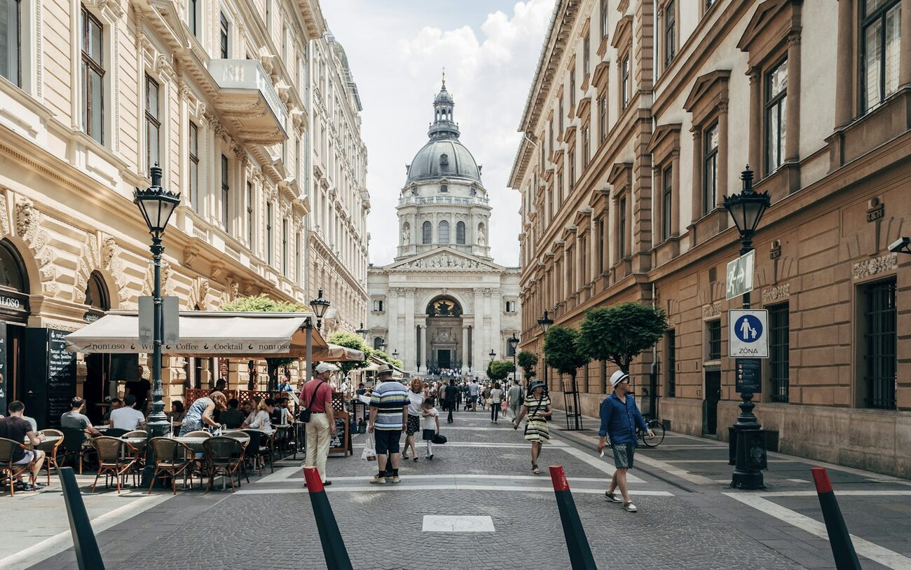 A café street in central Budapest with St. Stephen's Basilica in the distance.