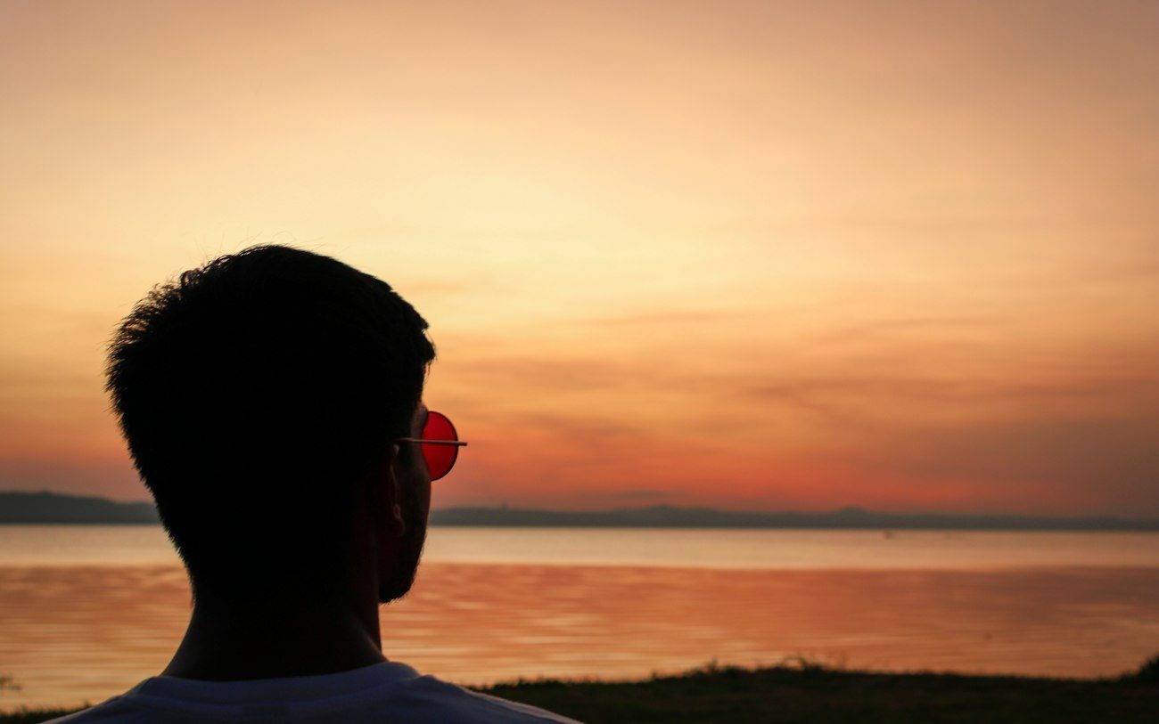 A person watching the sunset over the lake at San Bernardino, Paraguay.